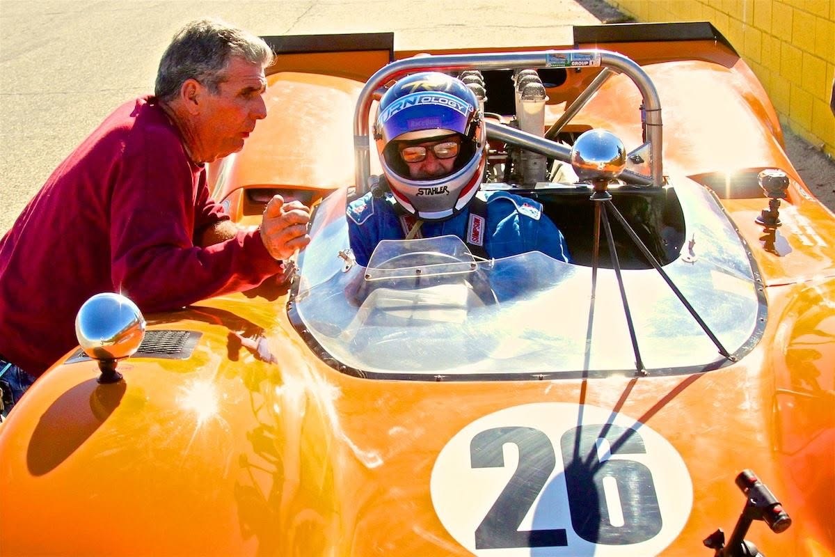 Tom Stahler seated in a vintage racing car at the track